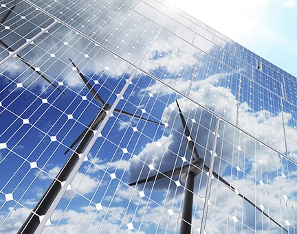 Wind turbines reflected in solar panels