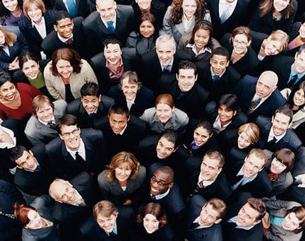 Large group of business people standing and looking up at camera